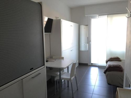 a small kitchen with a table and a room at Residence La Nave in Senigallia