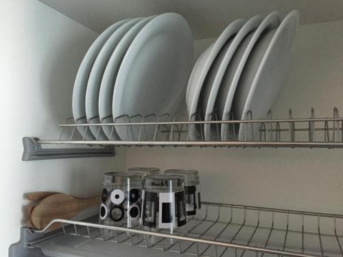 a kitchen shelf with plates and cups on it at Residence La Nave in Senigallia
