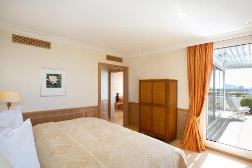 a bedroom with a bed and a large window at Hotel Stadt Freiburg in Freiburg im Breisgau