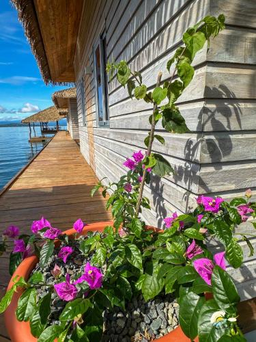 a porch with flowers on the side of a house at CoralBay Bungalows Solarte in Solarte