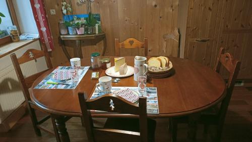 a wooden table with food on top of it at La Grand'Raie Table d'hôtes in Les Gras