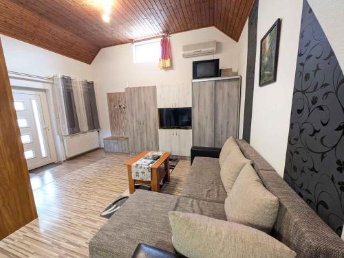 a living room with a couch and a table at Holiday home in Sagvar - Südtransdanubien 53171 in Ságvár