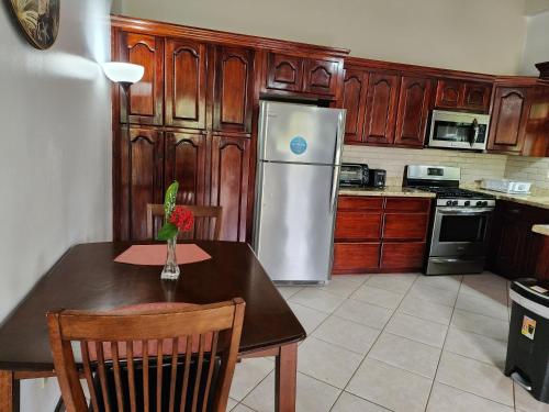 a kitchen with a table and a refrigerator at Caribbean Shores Belize in Hopkins