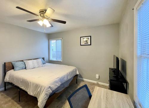 a bedroom with a bed and a ceiling fan at Homestead Haven in Concord