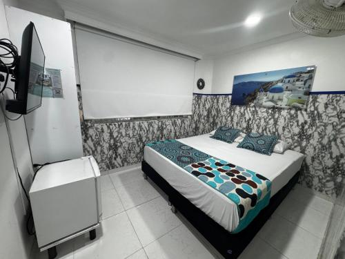 a bedroom with a bed and a projection screen at Casa Hotel Manco Mora in Medellín
