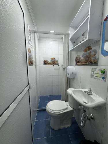 a small bathroom with a toilet and a sink at Casa Hotel Manco Mora in Medellín