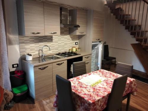 a kitchen with a table and a sink and a stove at La Baita in Pratola Peligna