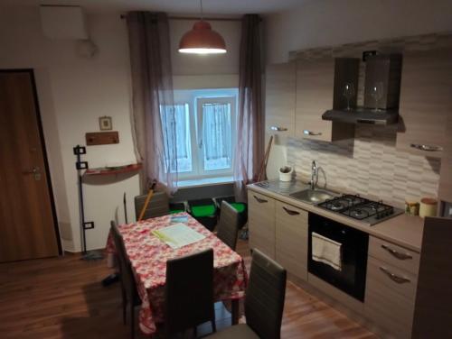 a kitchen with a table and a kitchen with a stove at La Baita in Pratola Peligna