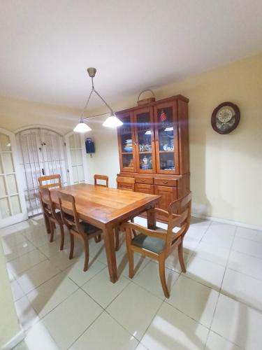a dining room with a wooden table and chairs at Casa do Bosque, 367 in Rio das Ostras