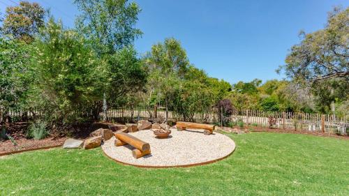 a garden with two couches and a fire pit at Baringa House in Shoreham