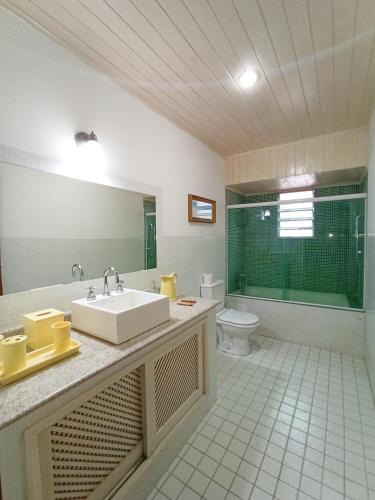 a bathroom with a sink and a toilet at Casa do Bosque, 367 in Rio das Ostras