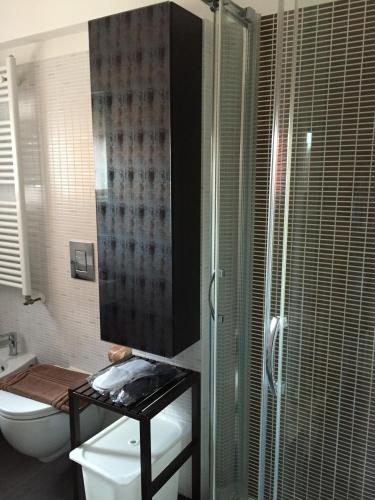a bathroom with a toilet and a glass shower at Residence La Nave in Senigallia