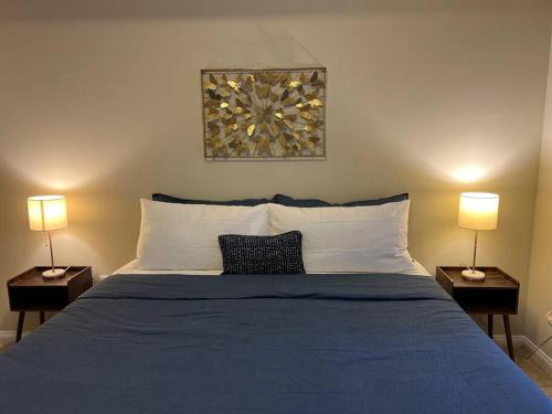 a bedroom with a blue bed with two lamps at Spacious 1bdrm apartment 10 mins to Cedars-Sinai by car FREE Parking, King bed in Los Angeles