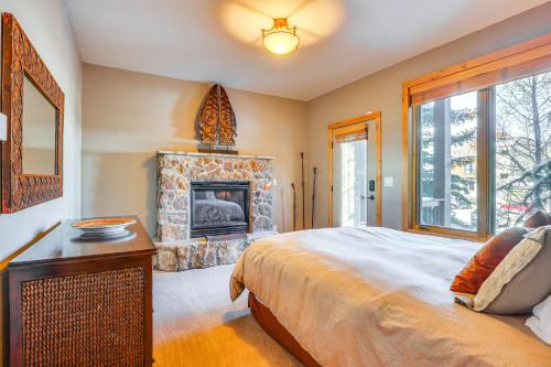 a bedroom with a large bed and a fireplace at Dtwn Frisco Home with Mtn View, 11 Mi to Ski Breck! in Frisco