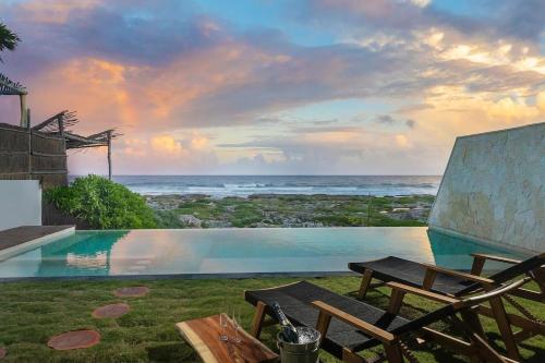 a swimming pool with a view of the ocean at Oceanview villa 4BR Concierge Service in Tulum