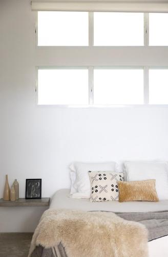 a bedroom with white walls and a bed with pillows at THE BEACH HAVENS - Haven Oceana in Emerald Beach