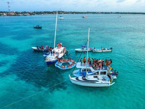 a group of people on boats in the water at Hidden Treasure Vacation Home Bay Blue Suite 2 in Belize City