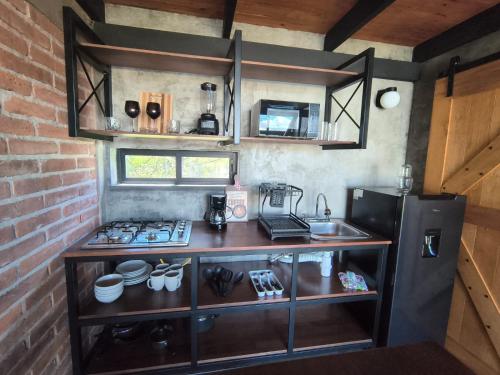 a small kitchen with a counter and a refrigerator at Cabañas pareja Tapalpa LUNA AZUL in Tapalpa