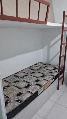 a mattress sitting on a shelf in a room at Apartamento Morada do Sol in Ilha Comprida