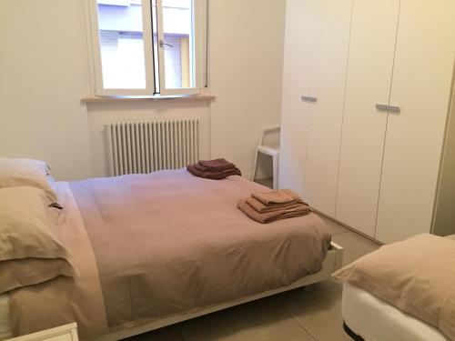 a bedroom with a bed with towels on it at Residence La Nave in Senigallia