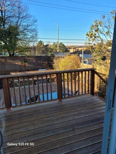 a wooden deck with a railing on a house at Home away from home in Brampton