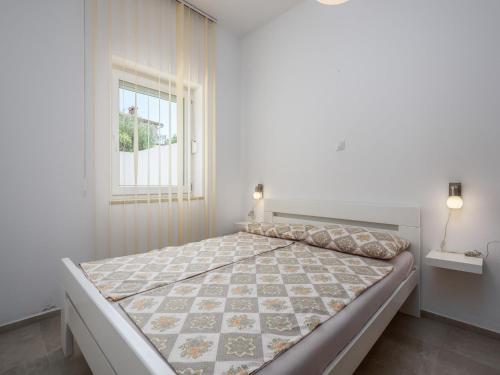 a white bedroom with a large bed with a window at Apartment in Kukci with Heated Pool in Kukci