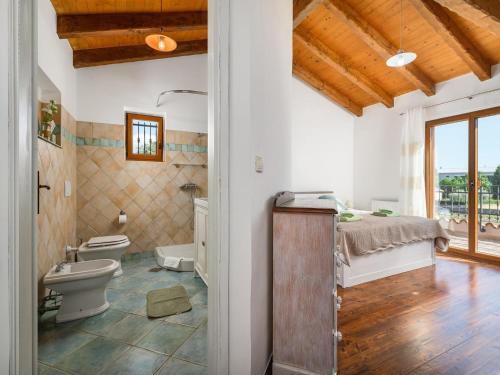 a bathroom with a toilet and a bed in a room at Villa in Sveti Lovrec near Ski Resort in Radetići