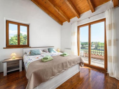 a bedroom with a bed and a large window at Villa in Sveti Lovrec near Ski Resort in Radetići