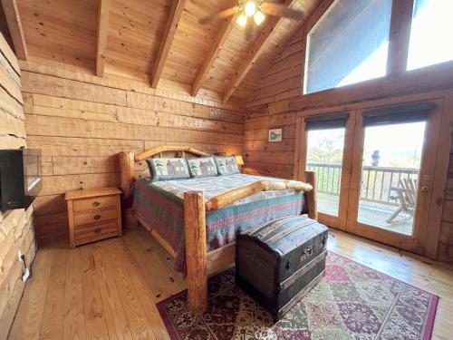 a bedroom with a bed in a log cabin at Honeymoon View #1 in Little Cove