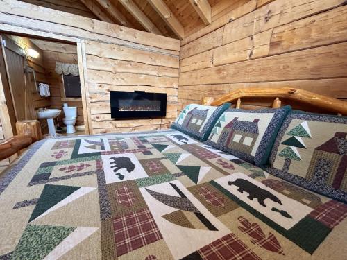 a bedroom with a bed in a log cabin at Honeymoon View #1 in Little Cove