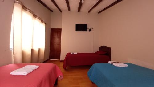 Gulta vai gultas numurā naktsmītnē MANDALA HOSTAL CUENCA