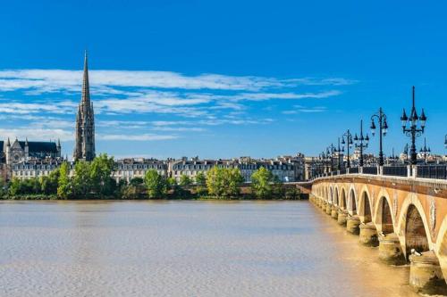 a bridge over a river with a city in the background at Luxurious villa with private pool in Salles
