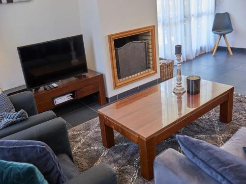 a living room with a coffee table and a television at Luxurious villa with private pool in Salles