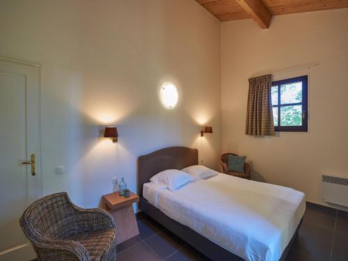 a bedroom with a bed and two chairs and a window at Luxurious villa with private pool in Salles