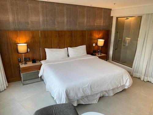 a bedroom with a large white bed and two lamps at Hotel Nacional Rio de Janeiro in Rio de Janeiro