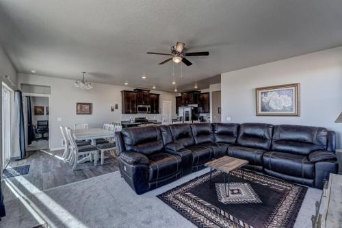 a living room with a leather couch and a table at Highly Accessible, Executive Style, Amazing View in Rapid City