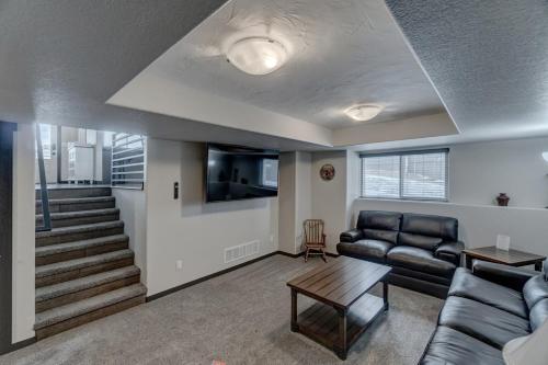 a living room with a couch and a table at Executive Golf Course Home, Family Friendly in Rapid City
