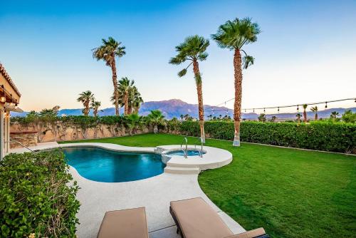 デザート・ホット・スプリングスにある360 Mountain Views, Pool and Spa by MariamsBnbのヤシの木が茂る裏庭