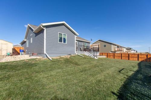 a yard with a house and a fence at Mini-Rushmore, Lots of Street Parking! in Rapid City