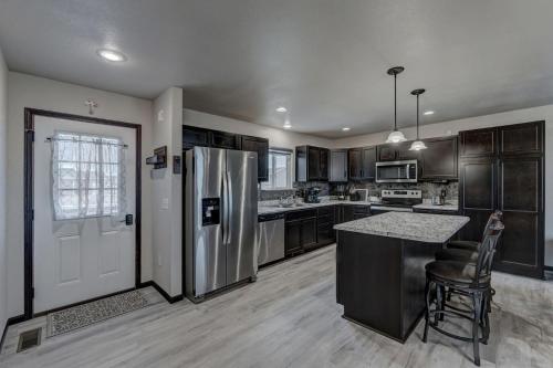 a kitchen with a stainless steel refrigerator and a counter at Mini-Rushmore, Lots of Street Parking! in Rapid City