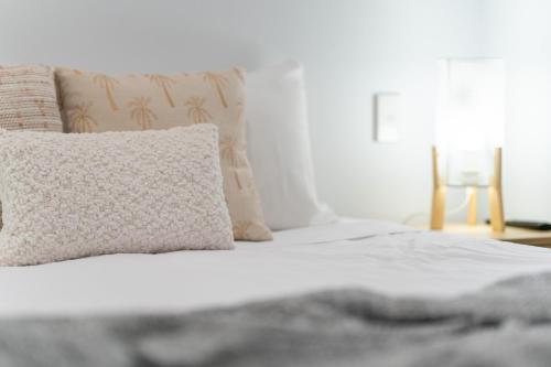 a white bed with a pillow and a window at BIG4 Tasman Holiday Parks - Rowes Bay in Townsville