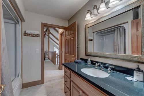 a bathroom with a sink and a mirror at Black Hills Nature Retreat, Centrally Located in Keystone