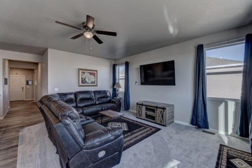 a living room with a couch and a ceiling fan at Highly Accessible, Executive Style, Amazing View in Rapid City