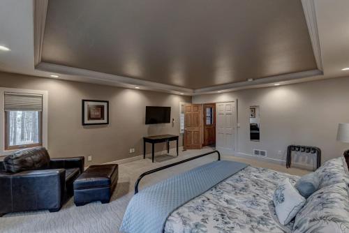 a large bedroom with a bed and a desk at Black Hills Nature Retreat, Centrally Located in Keystone