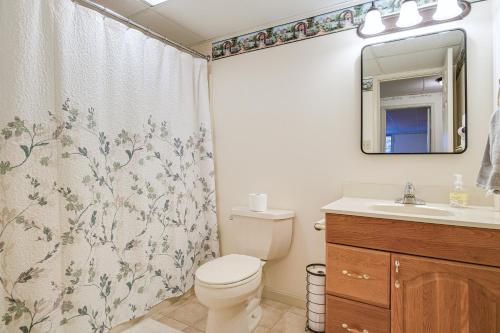 a bathroom with a toilet and a sink and a mirror at 4 Mi to the Amish Village Spacious Home with Deck! in Ronks