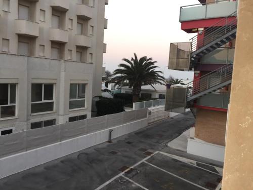 a view of a street between two buildings at Residence La Nave in Senigallia