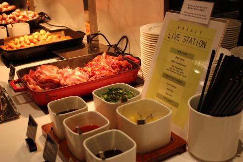 a table topped with dishes of food on a counter at The Grand Sumorum in Seogwipo