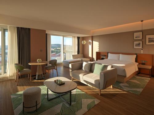a hotel room with a bed and a living room at Holiday Inn Quanzhou Donghai by IHG in Quanzhou