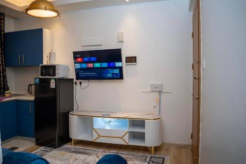 a small kitchen with a table and a refrigerator at Nairobi City view1 BDRM condo with pool and gym in Nairobi