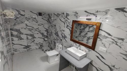 a bathroom with a sink and a mirror at DESERT OVERNIGHT LUXURY CAMP & ReSORT in Jaisalmer